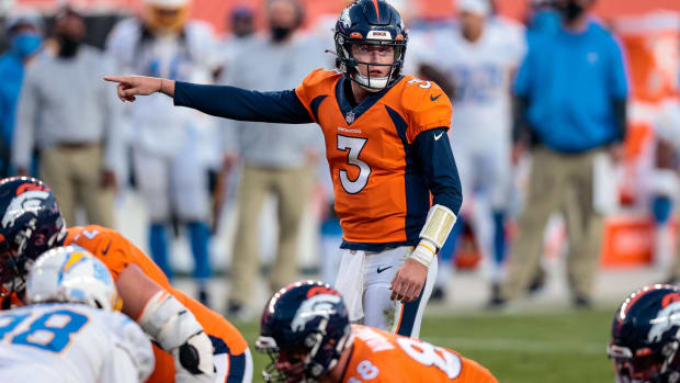 Denver Broncos quarterback Drew Lock (3) motions at the line of scrimmage in the fourth quarter against the Los Angeles Chargers at Empower Field at Mile High.